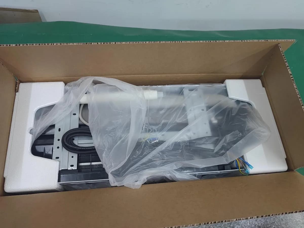 Indoor air conditioner unit inside an open carton with a protective bag and end supports